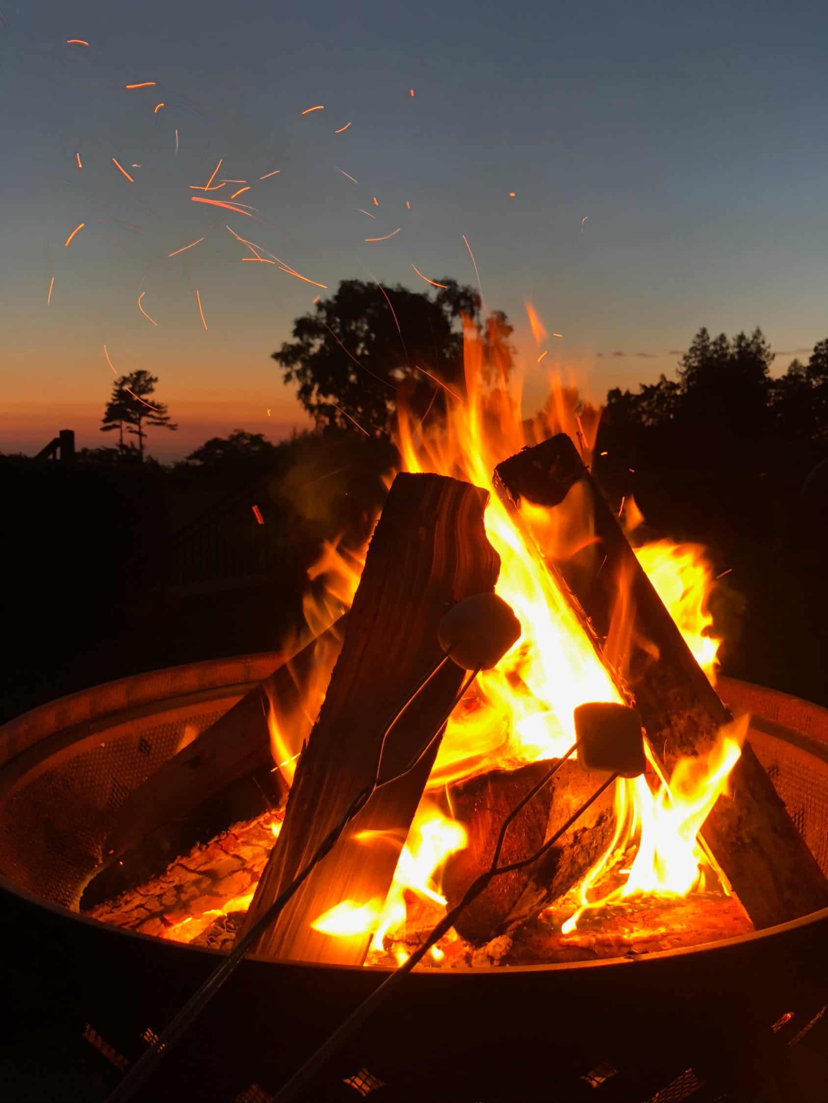 a roaring fire pit on a patio